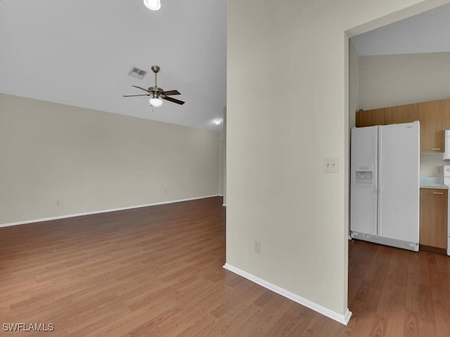 unfurnished living room featuring ceiling fan, lofted ceiling, and light hardwood / wood-style floors