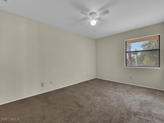 carpeted spare room featuring ceiling fan