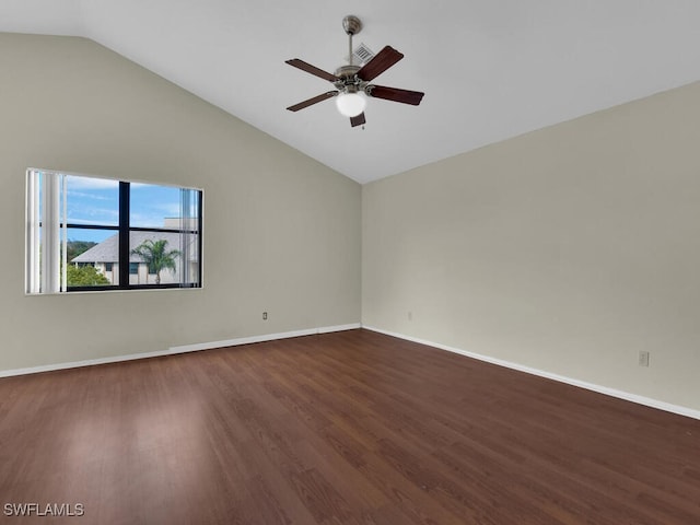 spare room with ceiling fan, dark hardwood / wood-style floors, and vaulted ceiling