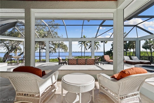 sunroom featuring a water view