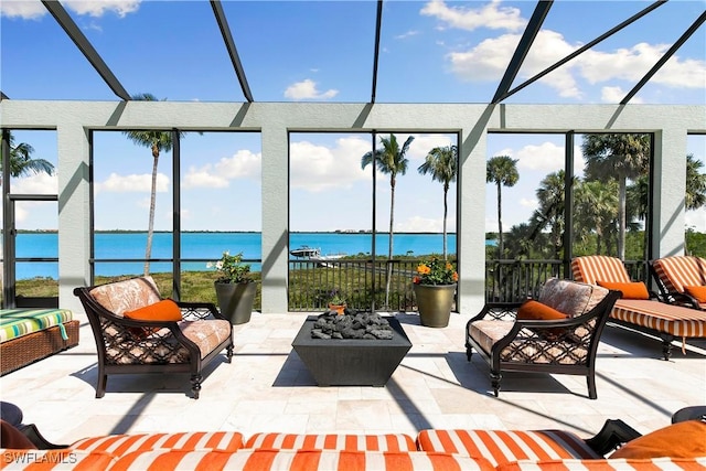 view of patio / terrace with an outdoor living space with a fire pit and a water view