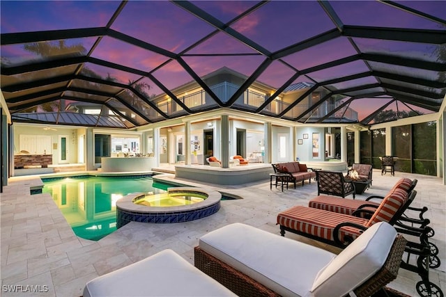 pool at dusk featuring a lanai, a patio, an outdoor hangout area, and an in ground hot tub