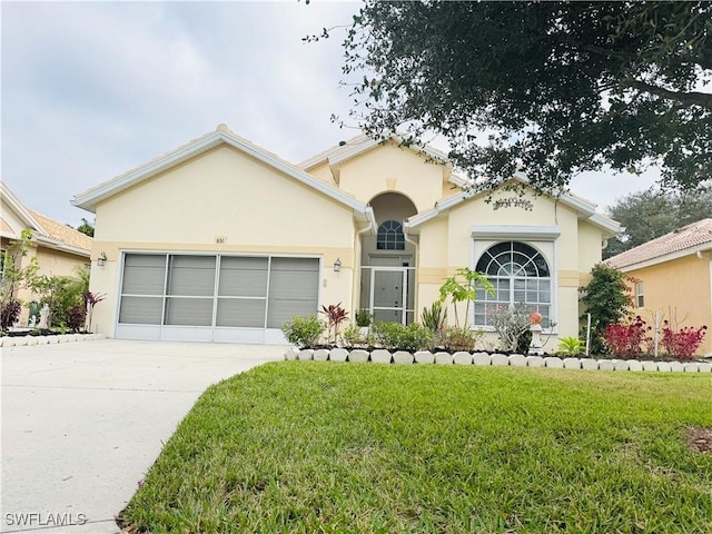 view of front of property with a garage and a front lawn