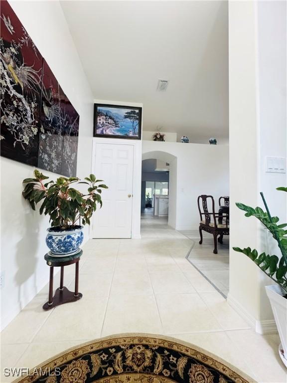 hall with tile patterned floors