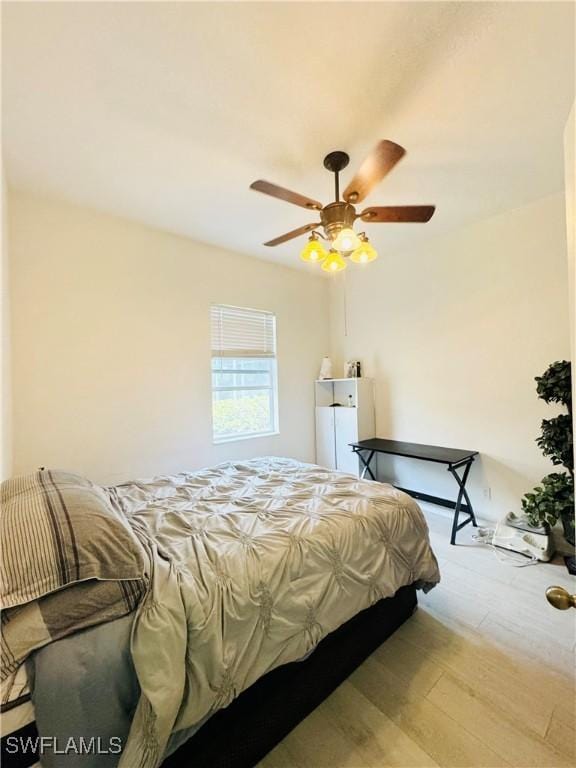 bedroom with ceiling fan and light hardwood / wood-style floors