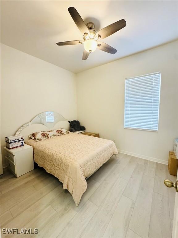 bedroom with ceiling fan and hardwood / wood-style floors