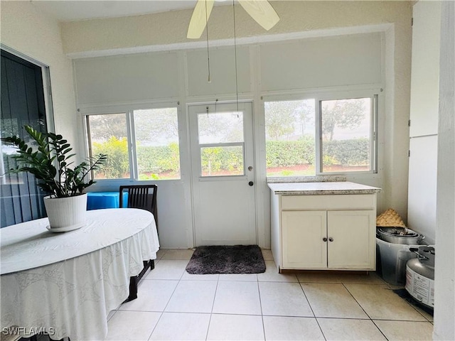 sunroom featuring ceiling fan and a wealth of natural light