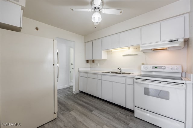 kitchen with white appliances, white cabinets, light hardwood / wood-style floors, and sink