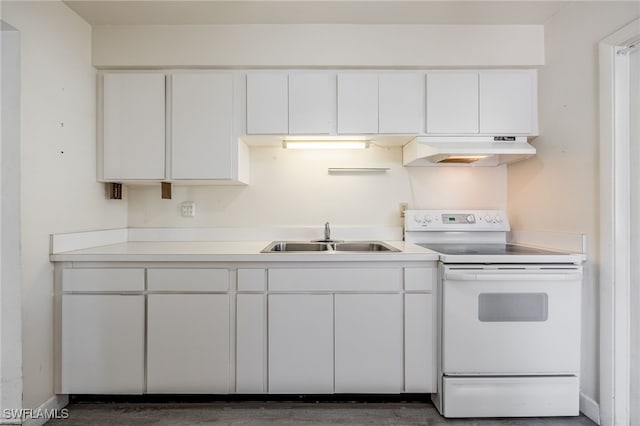 kitchen with white range with electric cooktop, white cabinets, and sink