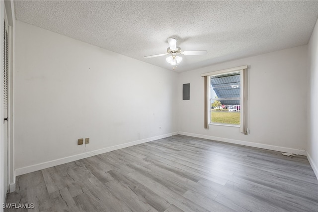 unfurnished room featuring a textured ceiling, ceiling fan, and light hardwood / wood-style flooring