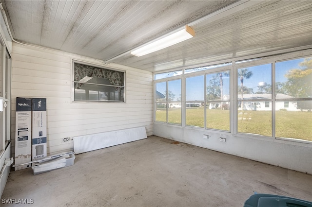 unfurnished sunroom featuring radiator heating unit