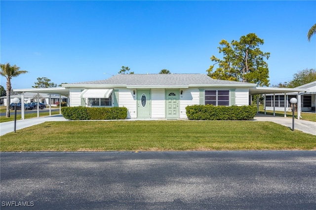 ranch-style house featuring a front lawn and a carport