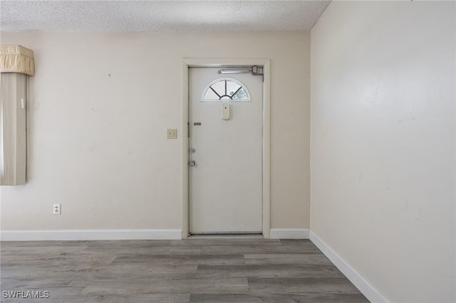 foyer featuring a textured ceiling and hardwood / wood-style floors