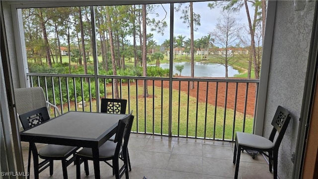 sunroom / solarium featuring a water view