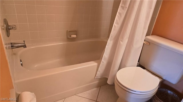 bathroom featuring toilet, tile patterned flooring, and shower / tub combo with curtain