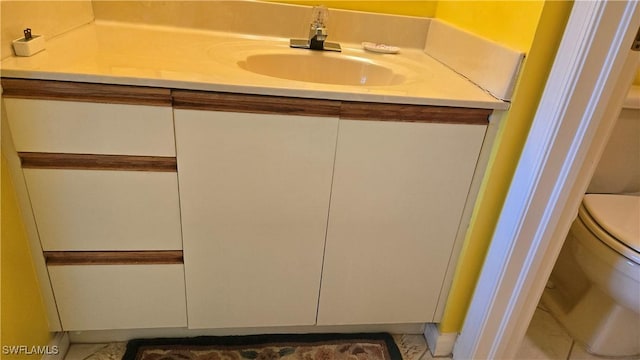 bathroom with toilet and vanity