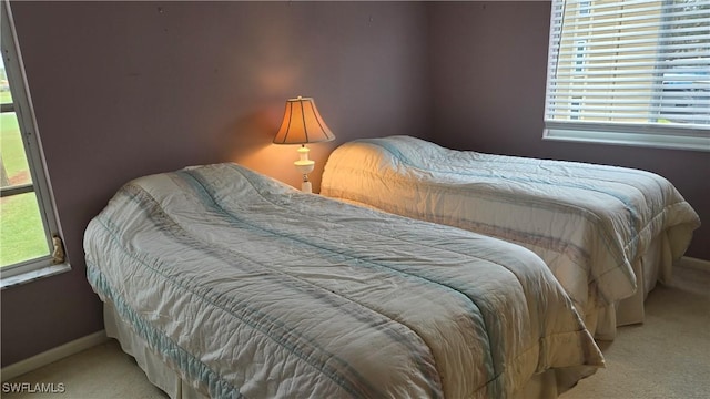 carpeted bedroom with multiple windows