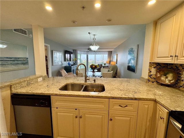 kitchen featuring light stone counters, kitchen peninsula, stainless steel dishwasher, and sink