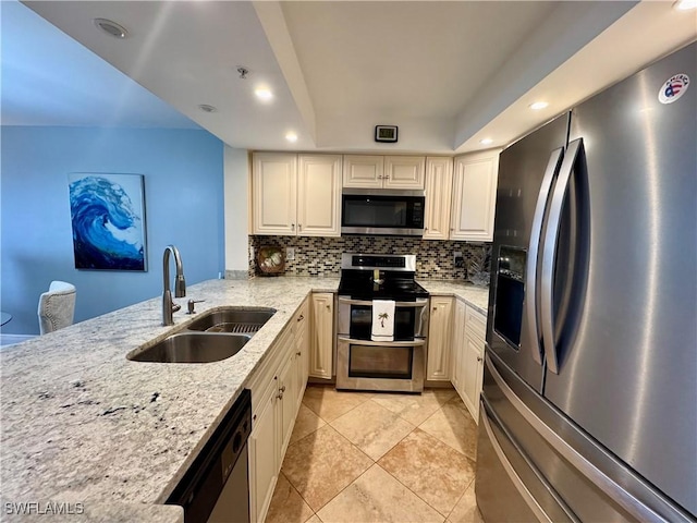 kitchen with stainless steel appliances, sink, light stone counters, light tile patterned flooring, and backsplash