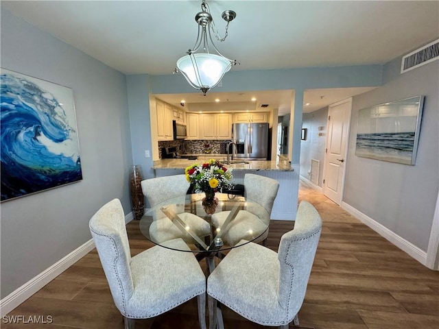 dining area with sink and dark hardwood / wood-style floors