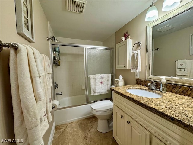 full bathroom featuring tile patterned floors, shower / bath combination with glass door, vanity, and toilet