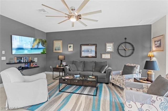 carpeted living room with ceiling fan