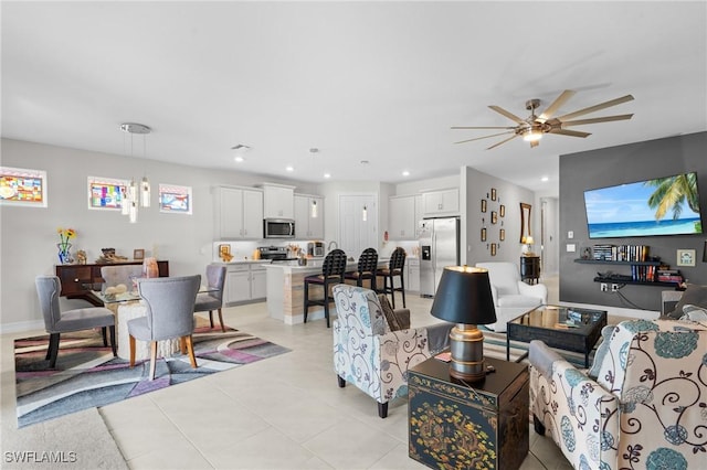 living room with ceiling fan and light tile patterned floors