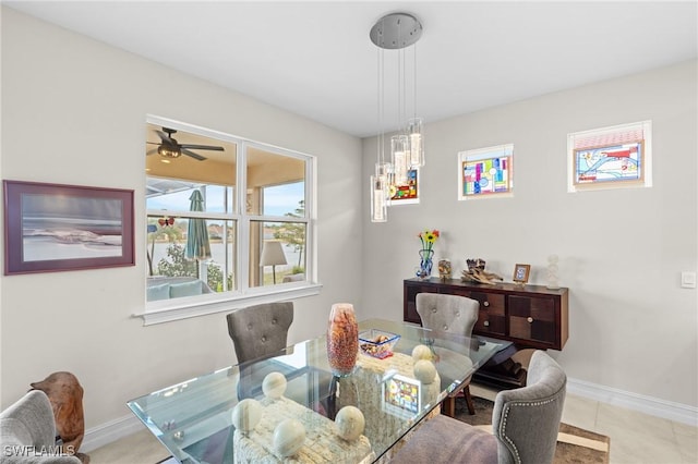 tiled dining room featuring ceiling fan