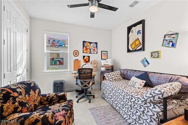 bedroom with ceiling fan, light tile patterned floors, and a closet