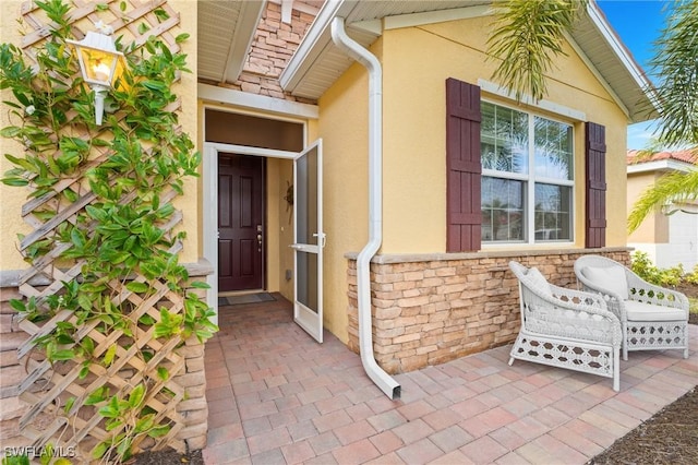 property entrance featuring a patio