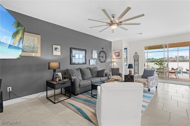 tiled living room featuring ceiling fan