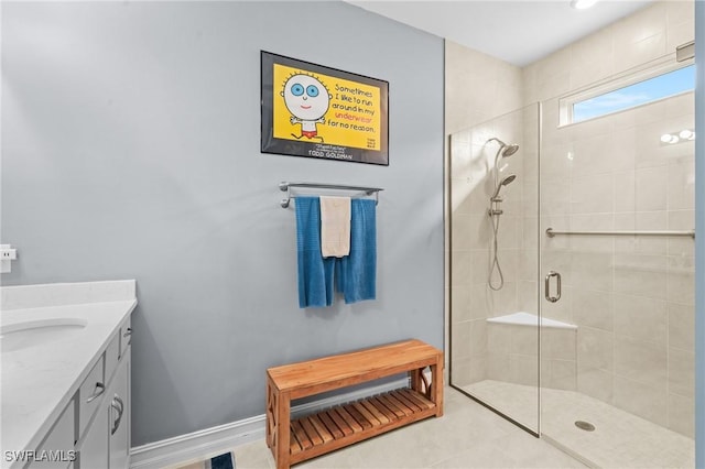 bathroom featuring a shower with shower door, vanity, and tile patterned flooring