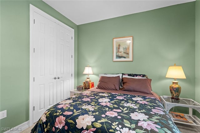 bedroom with carpet and a closet