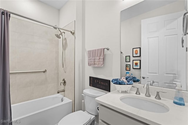 full bathroom with toilet, vanity, and tiled shower / bath