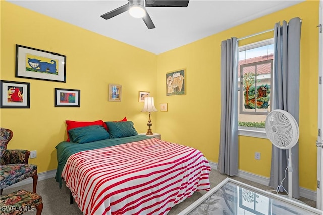 bedroom with ceiling fan, carpet flooring, and multiple windows