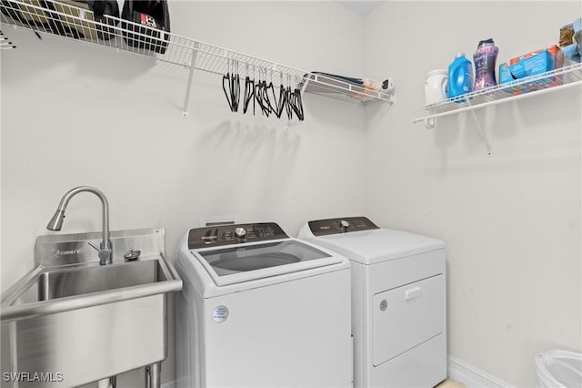 washroom with washing machine and dryer and sink