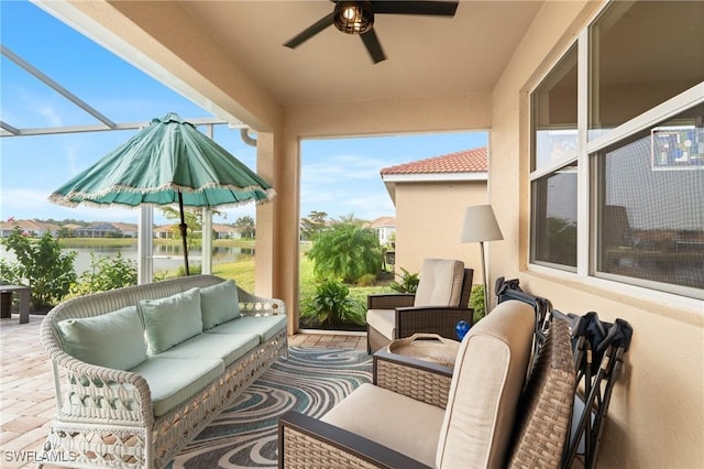 view of patio featuring an outdoor hangout area, ceiling fan, and a water view