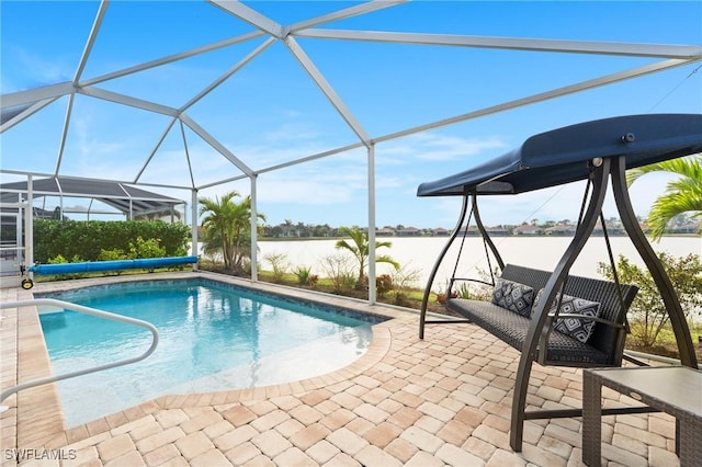 view of swimming pool with a lanai, a water view, and a patio