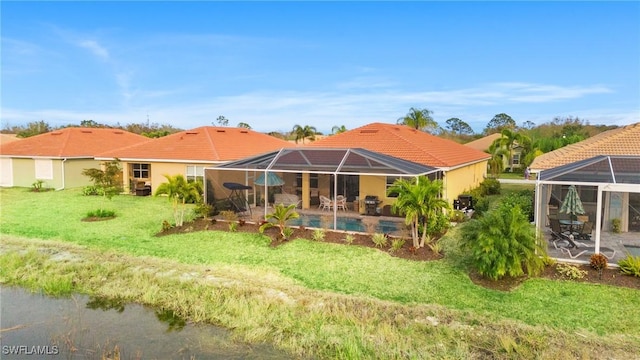 back of house featuring a patio area, a lanai, and a yard