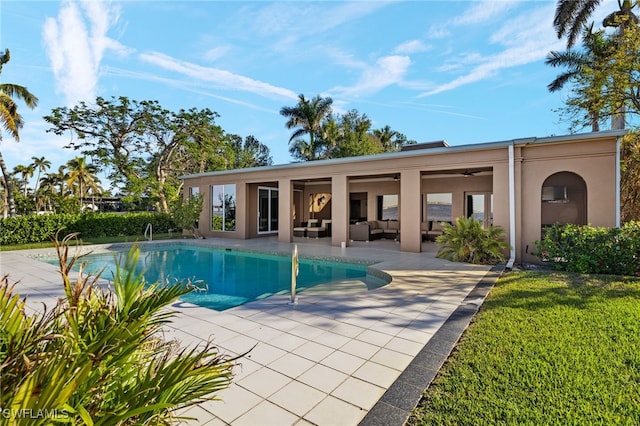 view of swimming pool featuring ceiling fan, outdoor lounge area, and a patio