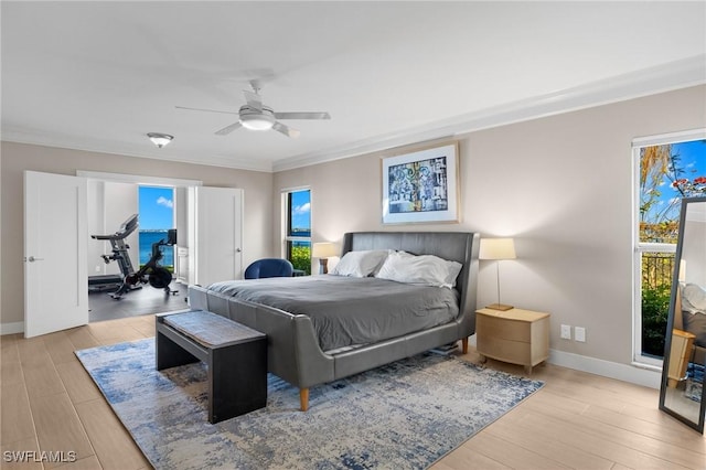 bedroom featuring ceiling fan, crown molding, and light hardwood / wood-style flooring