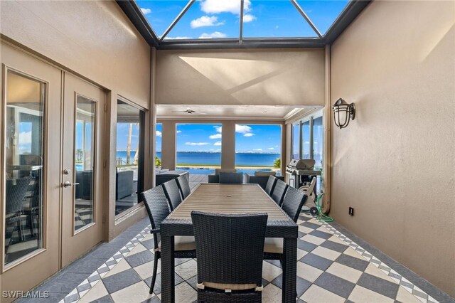 sunroom / solarium with a water view and plenty of natural light