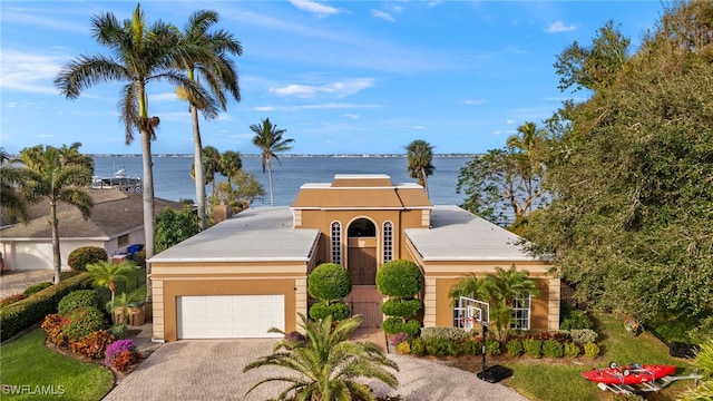 view of front of property with a water view and a garage