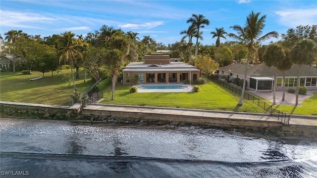 view of home's community featuring a water view, a pool, and a yard