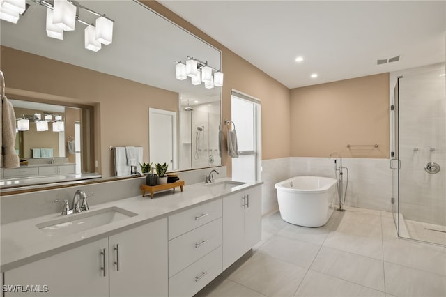 bathroom featuring tile patterned floors, vanity, and plus walk in shower