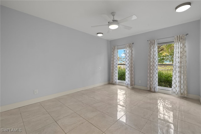 tiled spare room with ceiling fan