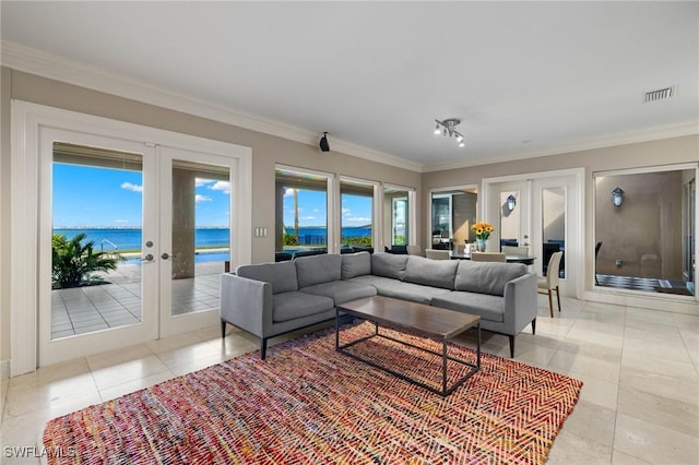 living room featuring plenty of natural light, crown molding, a water view, and french doors