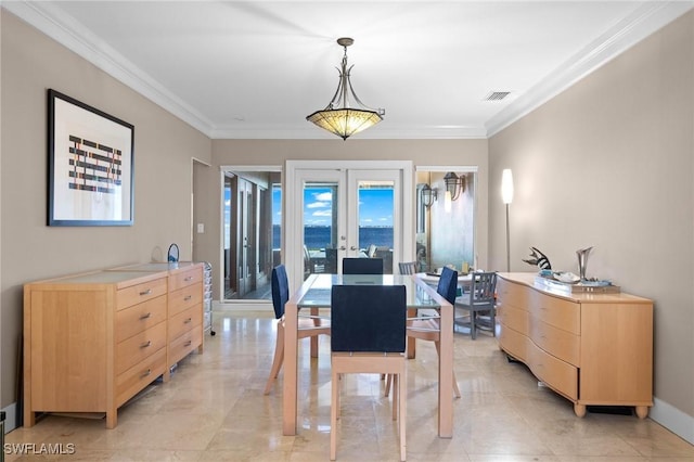 dining area with crown molding and french doors