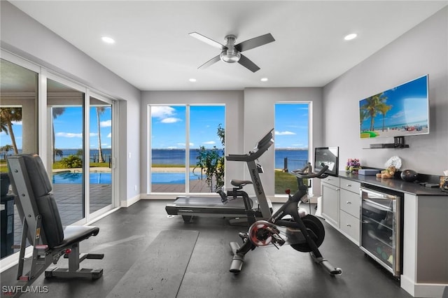 exercise room with ceiling fan and beverage cooler