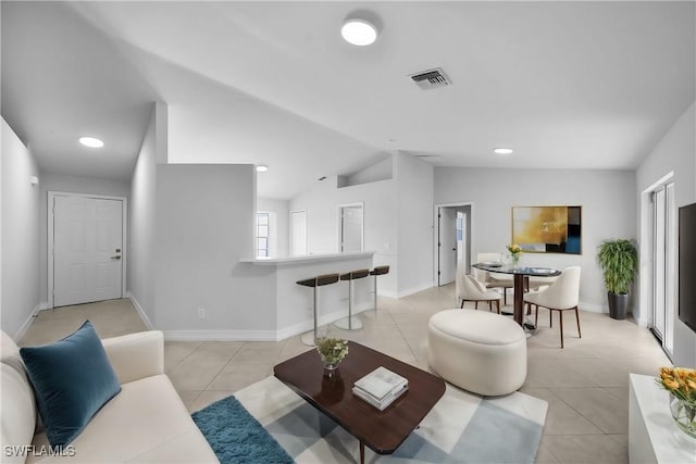 living room featuring lofted ceiling and light tile patterned flooring